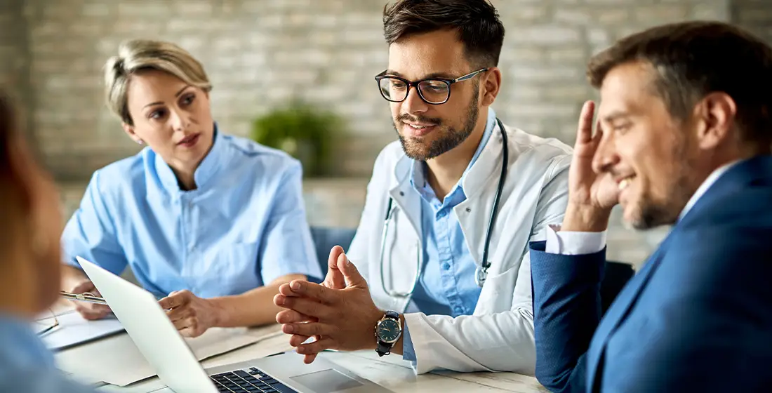 Three healthcare professionals discussing their payment processing solution.