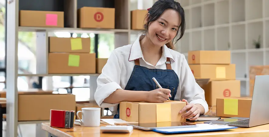 Small business owner processing returns and shipments from online purchases.
