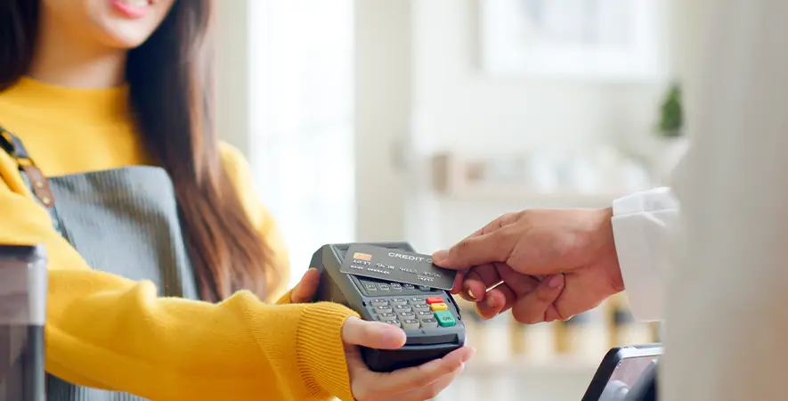A customer completes an in-person transaction with a wireless credit card terminal.