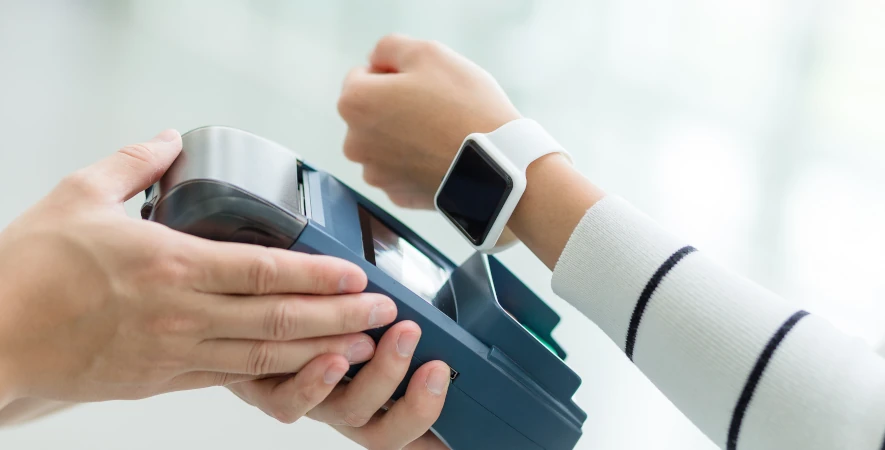 Apple Watch completes a digital wallet transaction on a mobile payment device.