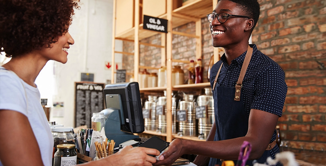 Customer completes a transaction with a digital wallet payment processing device.