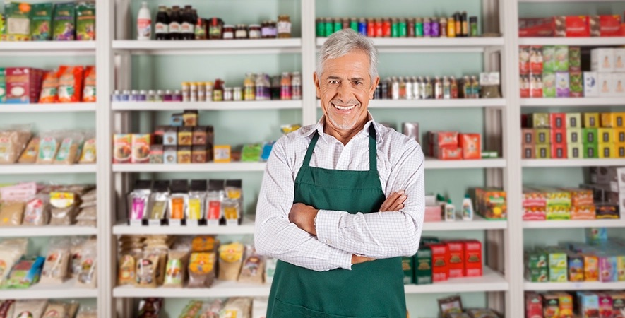 Store owner stands confidently after choosing the right payment processing provider.