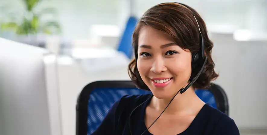 Payment processing customer service agent wearing a telephone headset.
