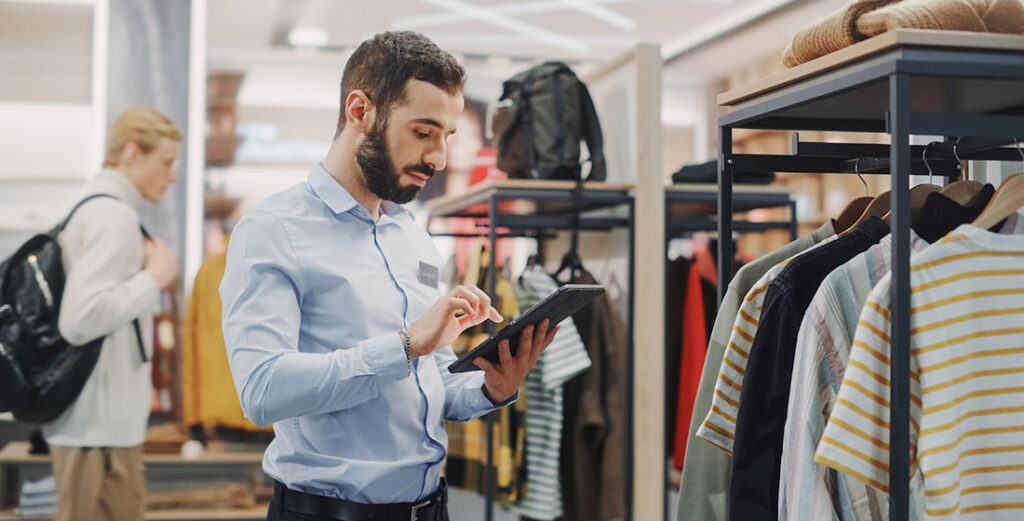 Retail associate reviews their merchant processing rates after switching to a simplified pricing plan.