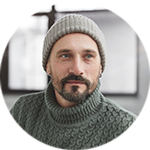 portrait picture of Paul Reed wearing a knit sweater and toque