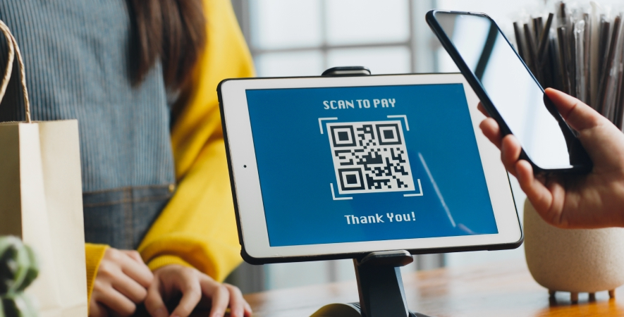 customer making payment by scanning QR code at checkout.