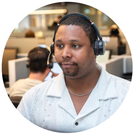 sekure representative at their desk listening to a customer explain their business' payment processing needs
