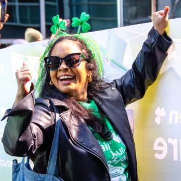 Sekure employee leading the St. Patrick's Day parade dressed in festive attire