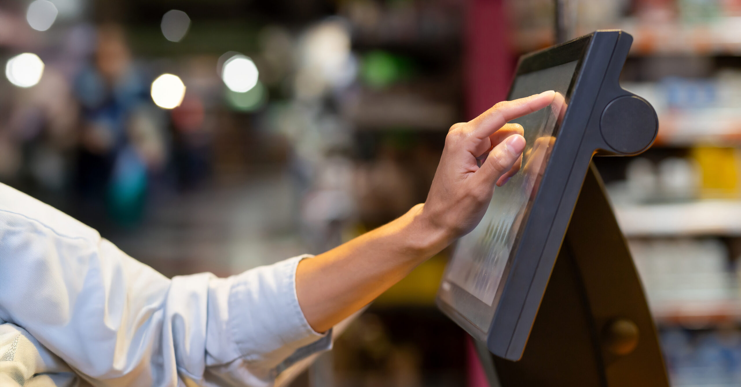 person tapping on POS screen