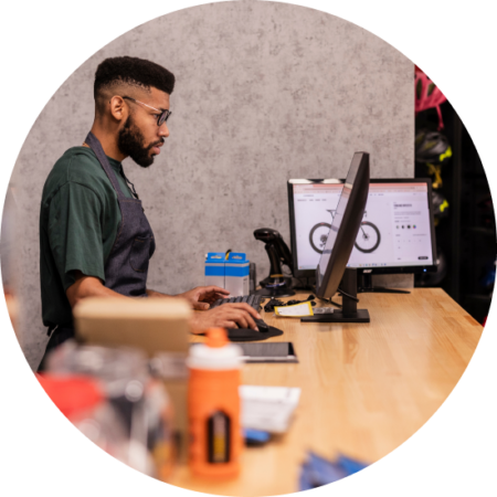 retail owner using pos system at checkout