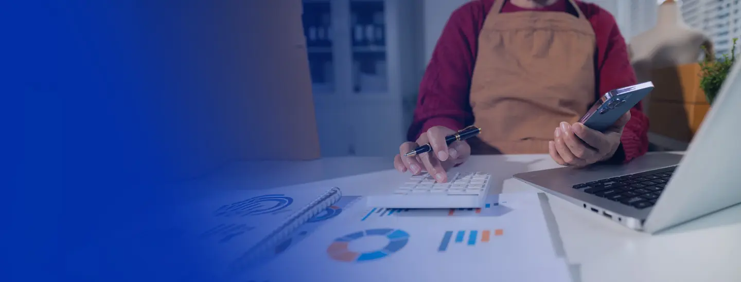 store owner calculating savings on their laptop