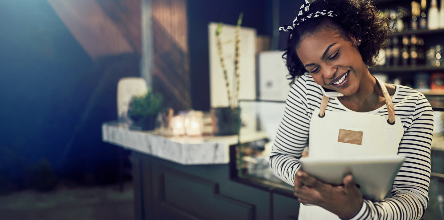 cafe owner talking on the phone while entering information into a tablet POS