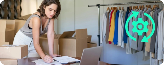 retail store owner reviewing inventory on their laptop and notepads and preparing items for shipping