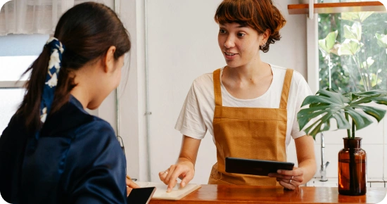 restaurant host talking to a customer about the menu