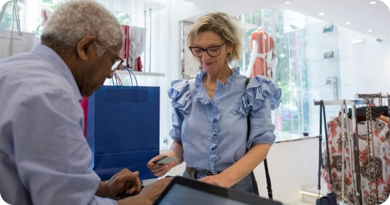 retail store employee cashing out customer with a tap to pay pos system